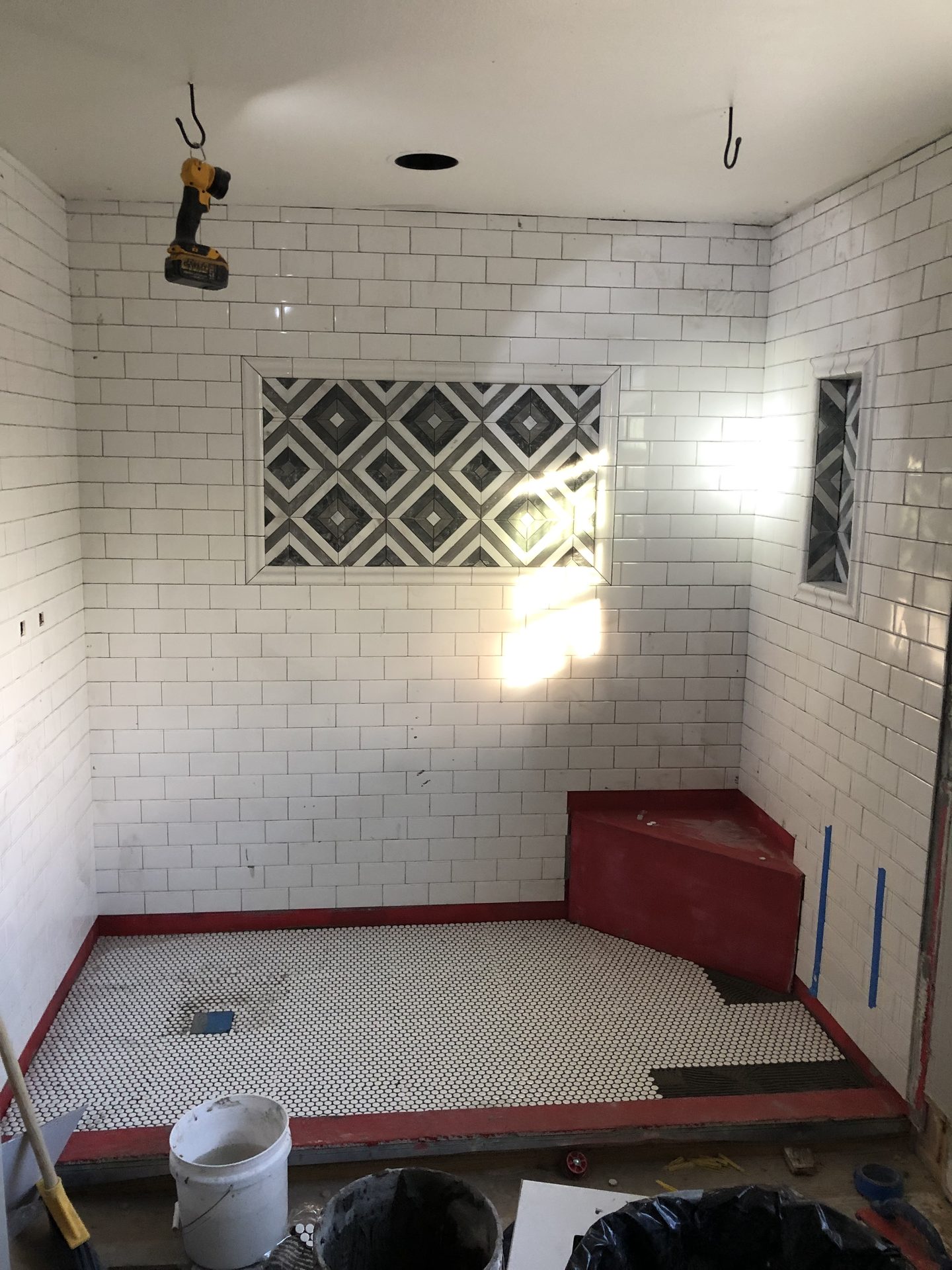 White subway tile and penny-round floor going in on the shower