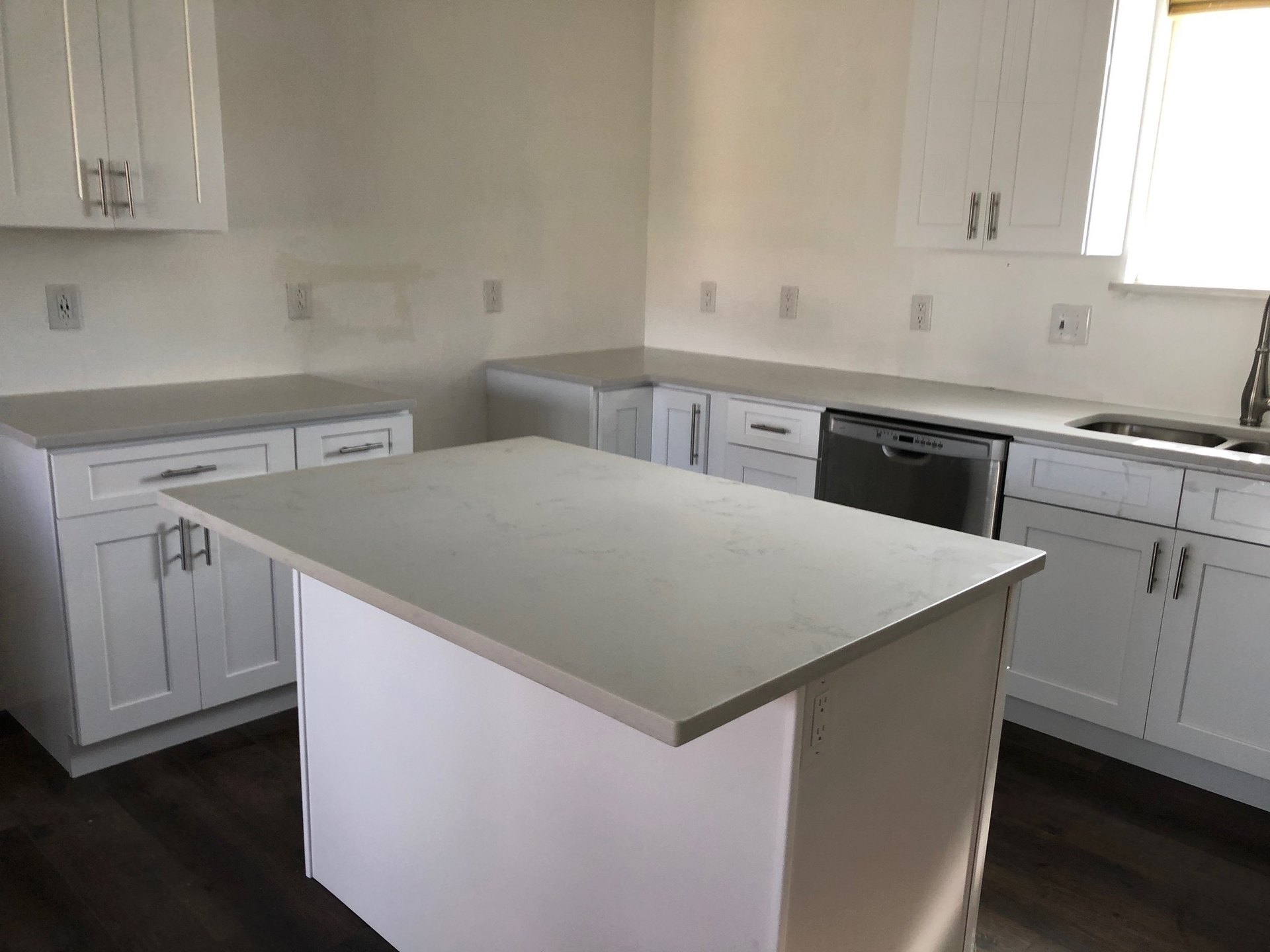 White shaker cabinets and island set, backsplash not in yet