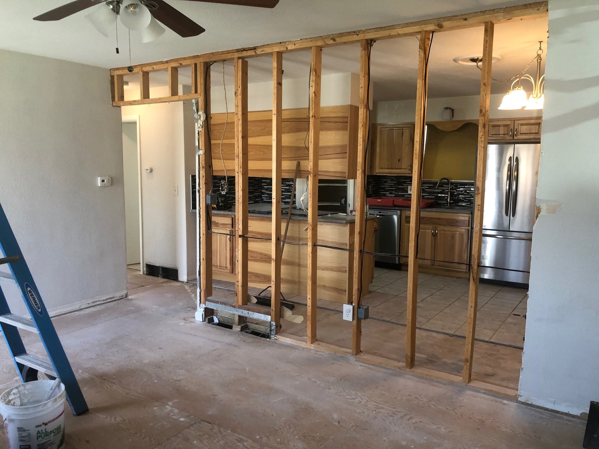 Wall opened to studs between living room and kitchen